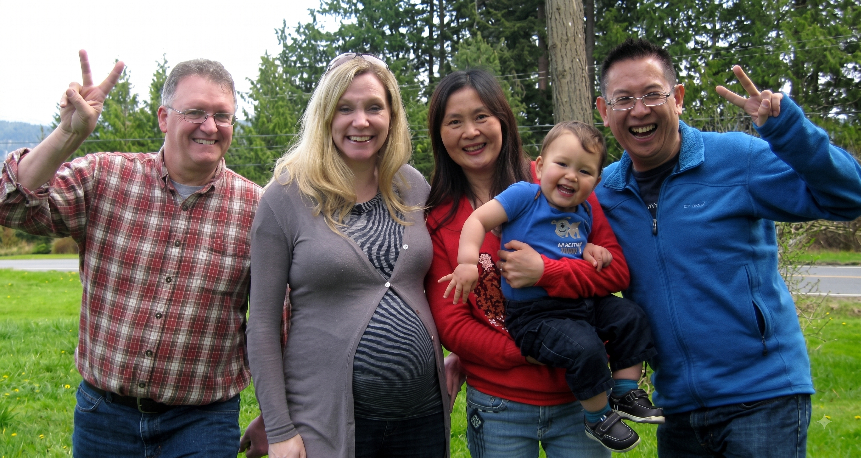 Two families together outdoors with their little boy