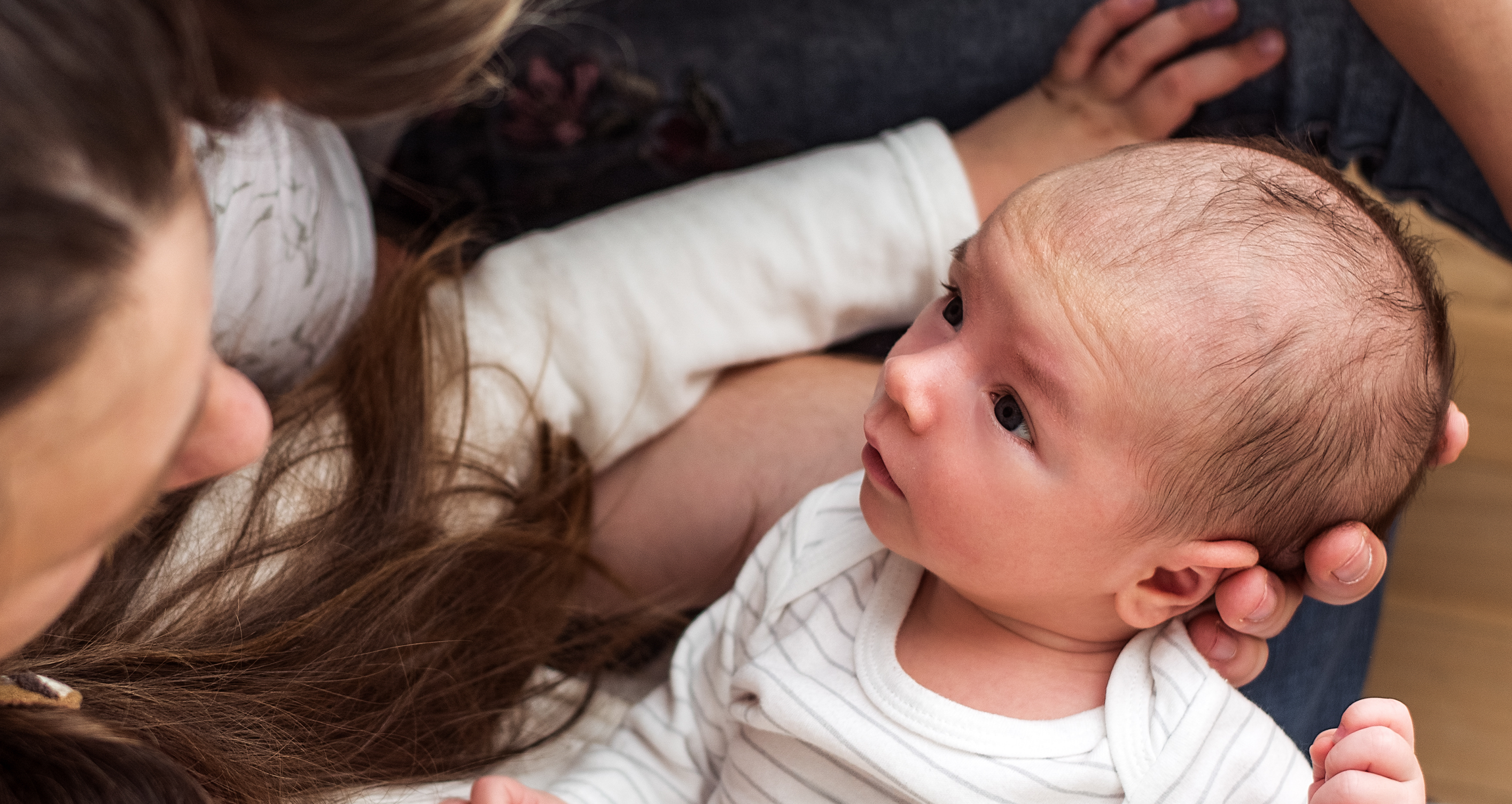 Parents gazing at their newborn baby
