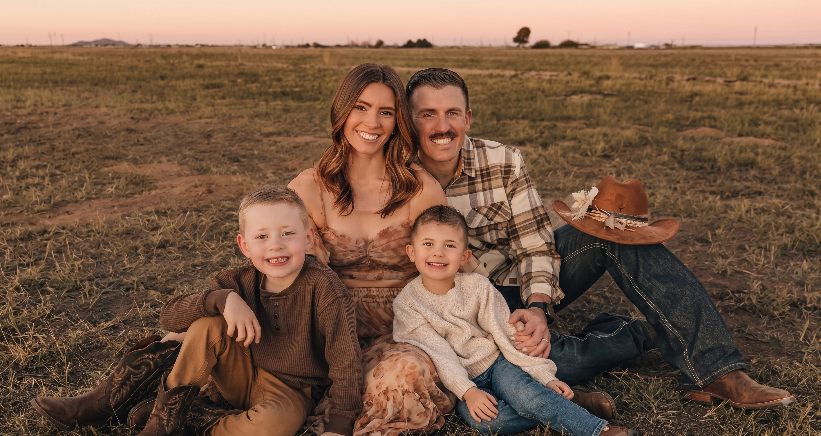 A family of four at sunset