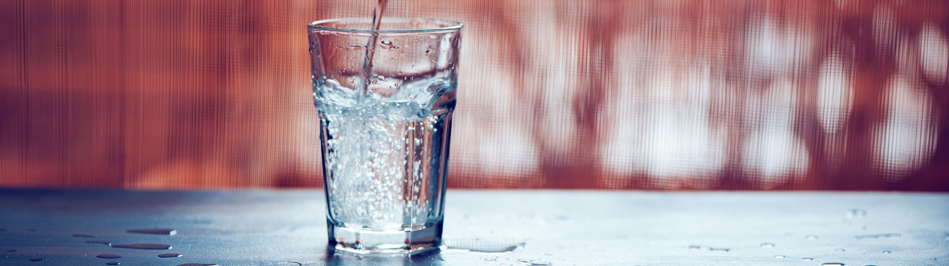 A glass of clean water being poured