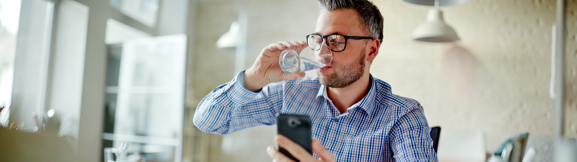 Man enjoying clean, odor-free water at home