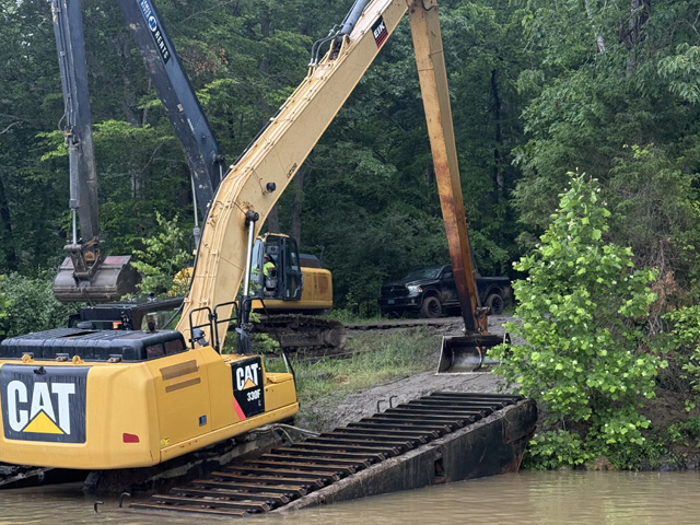 CAT long-reach excavator on shoreline
